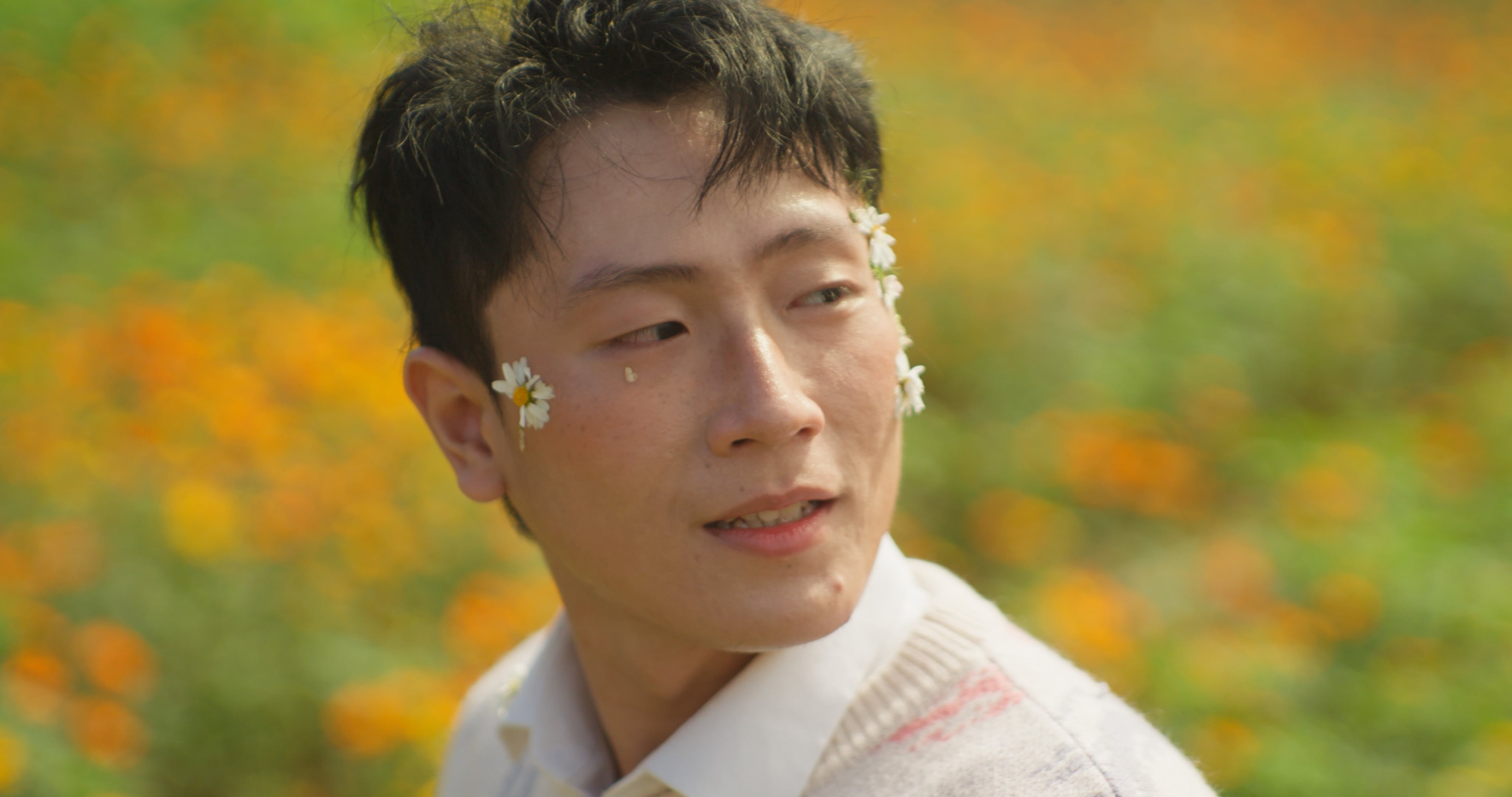 Young man in a white vest in a marigold field, plain Rec.709 conversion