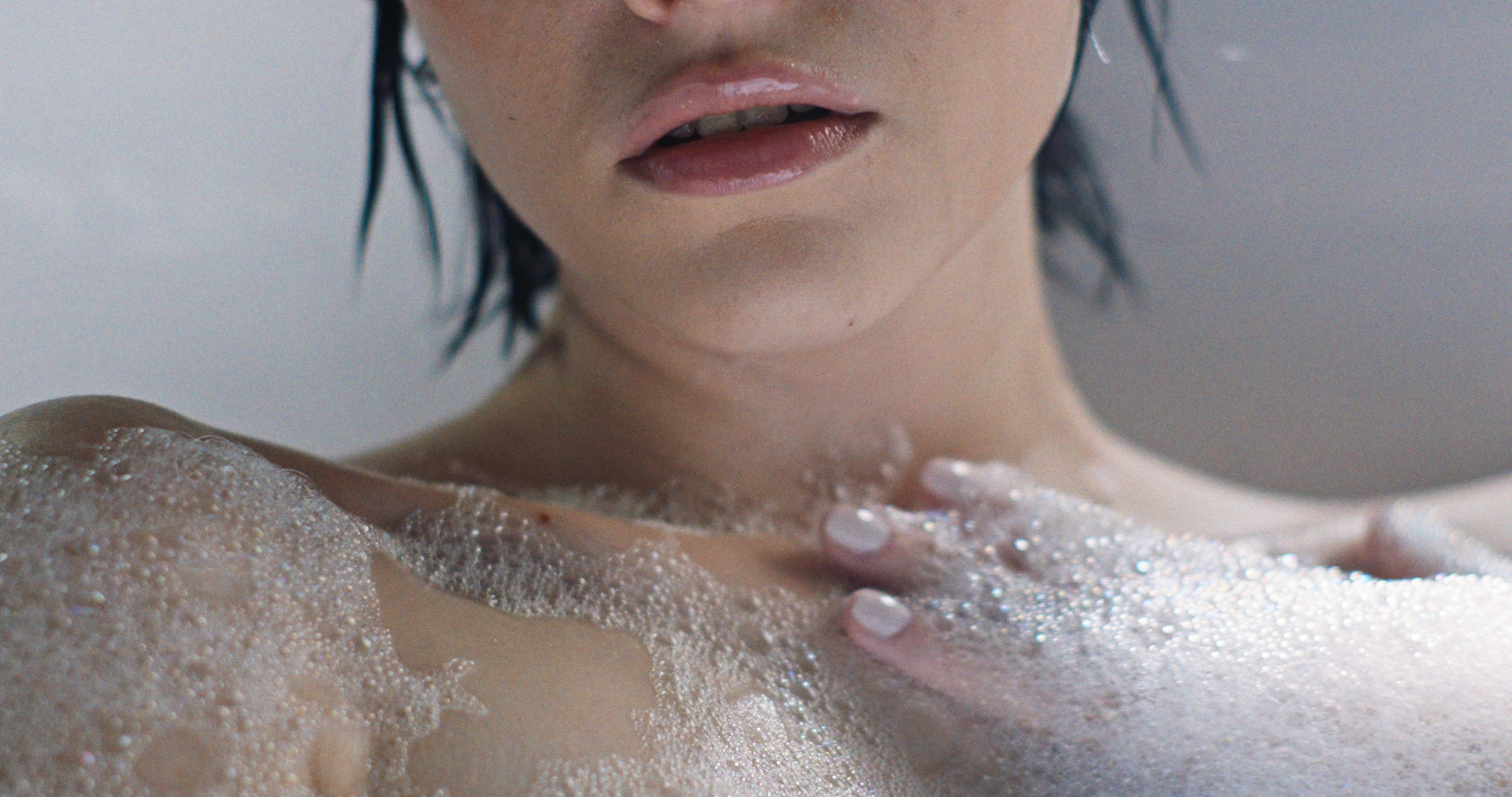 High-key close-up of a woman in a bath by window light, rendered through Latent