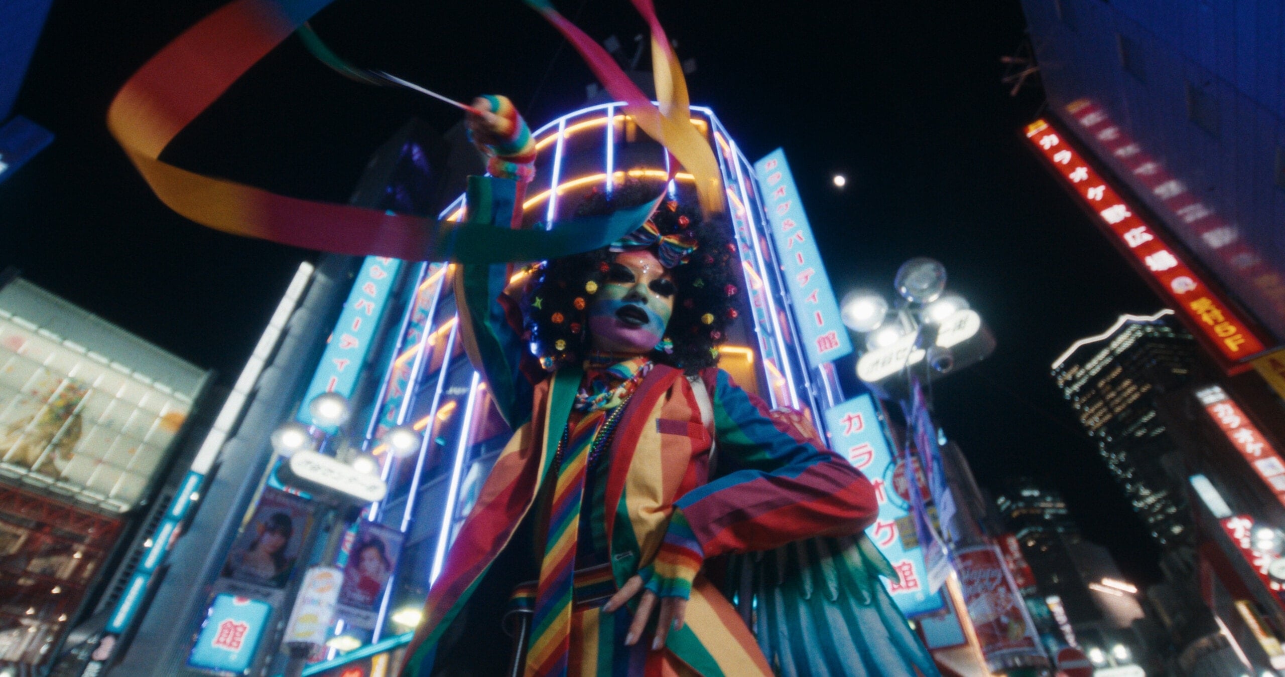 Ribbon performer under Tokyo neon at night, rendered through Latent's Default look